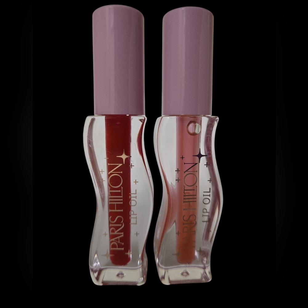 Paris Hilton Lip Oils (2) in red and pink shades.